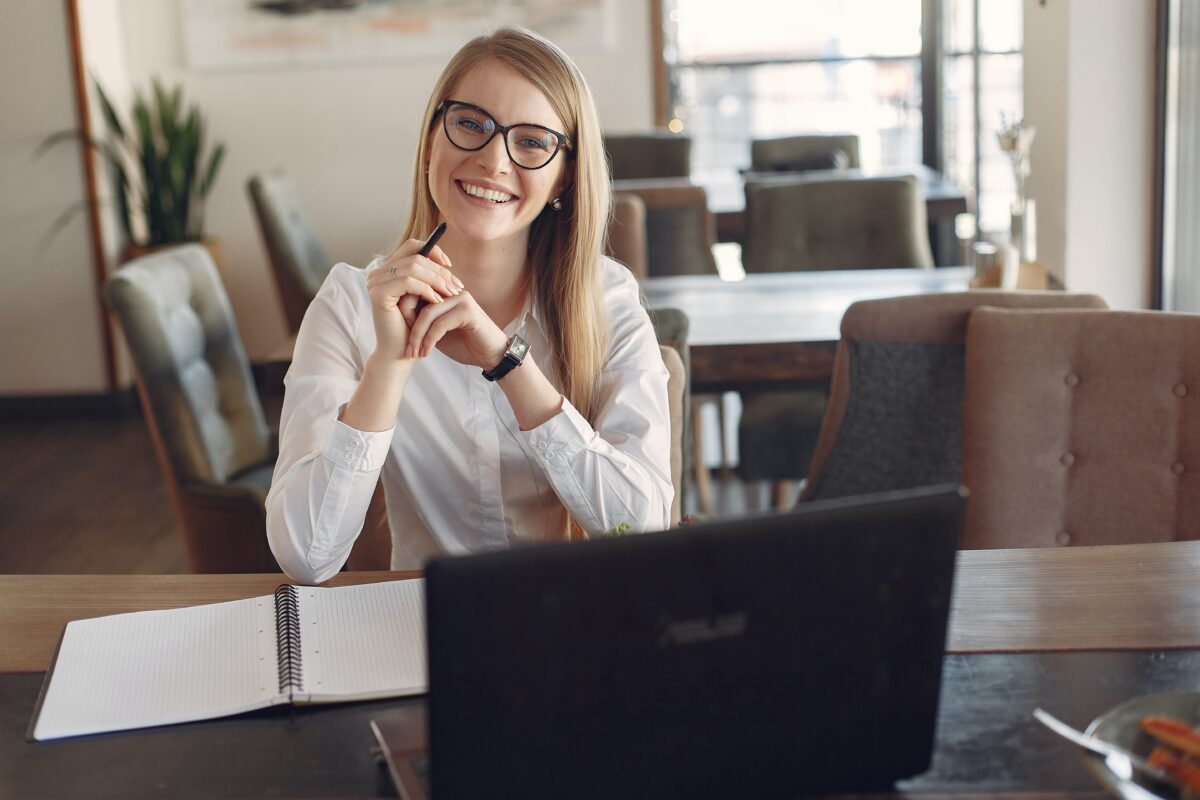Photo by Gustavo Fring from Pexels: https://www.pexels.com/photo/cheerful-young-businesswoman-in-eyeglasses-during-remote-work-in-cafeteria-3874619/